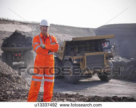Worker standing at coal mine View Large Photo Image Stock Image - Worker standing at coal mine. Fotosearch