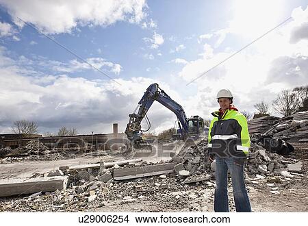 Worker standing on construction site View Large Photo Image Picture - Worker standing on construction site. Fotosearch