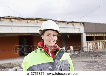 Worker standing on construction site View Large Photo Image Stock Image - Worker standing on construction site. Fotosearch