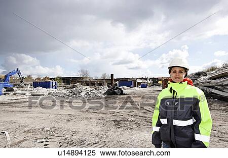 Worker standing on construction site View Large Photo Image Stock Photography - Worker standing on construction site. Fotosearch
