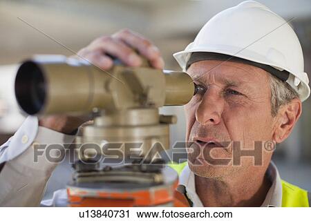 Stock Image - Worker using equipment on site. Fotosearch