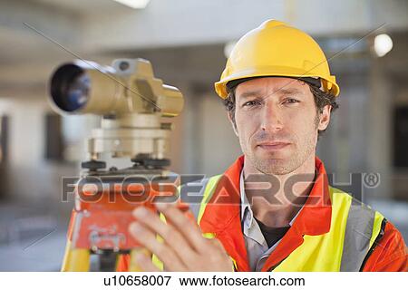 Stock Photo - Worker using equipment on site. Fotosearch
