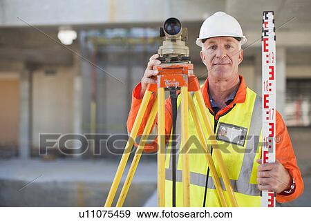 Worker using equipment on site View Large Photo Image Stock Photo - Worker using equipment on site. Fotosearch