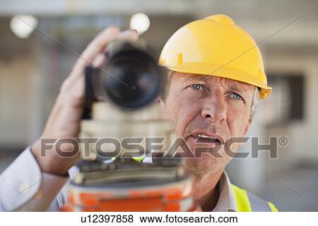 Worker using equipment on site View Large Photo Image Stock Photo - Worker using equipment on site. Fotosearch