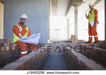 Worker using walkie talkie on site View Large Photo Image Stock Photograph - Worker using walkie talkie on site. Fotosearch