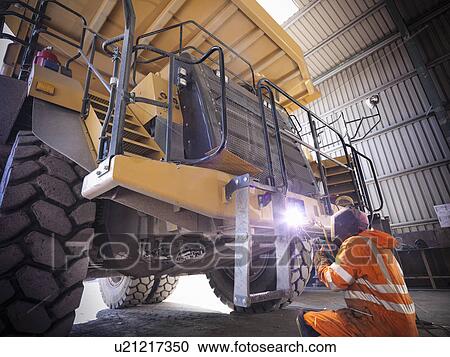 Worker welding truck in coal mine View Large Photo Image Stock Image - Worker welding truck in coal mine. Fotosearch