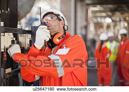 Worker with walkie talkie on site View Large Photo Image Stock Image - Worker with walkie talkie on site. Fotosearch