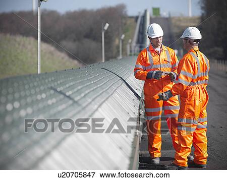 Stock Photo - Workers by conveyor at coal mine. Fotosearch