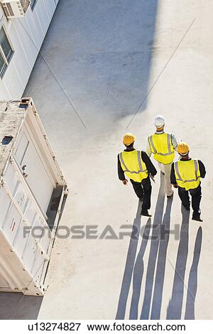 Workers casting shadows on site View Large Photo Image Stock Photo - Workers casting shadows on site. Fotosearch
