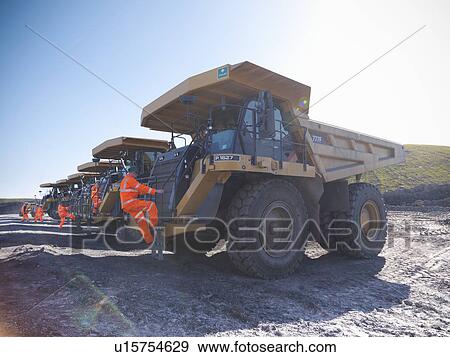 Workers climbing trucks at coal mine View Large Photo Image Stock Photo - Workers climbing trucks at coal mine. Fotosearch