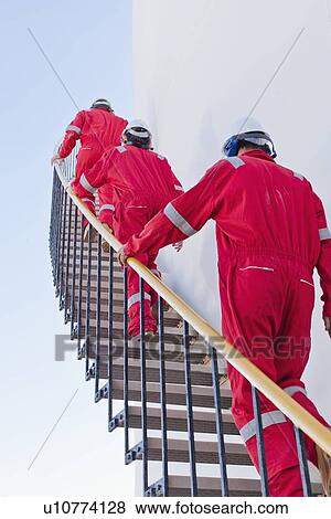 Stock Photo - Workers on steps at chemical plant. Fotosearch