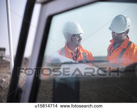 Picture - Workers reading blueprints at coal mine. Fotosearch