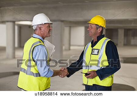 Picture - Workers shaking hands on site. Fotosearch