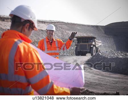 Workers standing at coal mine View Large Photo Image Stock Photo - Workers standing at coal mine. Fotosearch