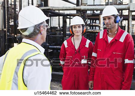 Workers talking at chemical plant View Large Photo Image Stock Image - Workers talking at chemical plant. Fotosearch