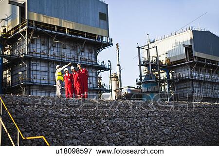Workers talking at chemical plant View Large Photo Image Stock Photo - Workers talking at chemical plant. Fotosearch