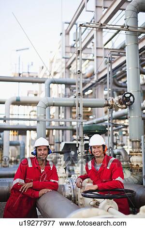 Workers talking at chemical plant View Large Photo Image Stock Photo - Workers talking at chemical plant. Fotosearch