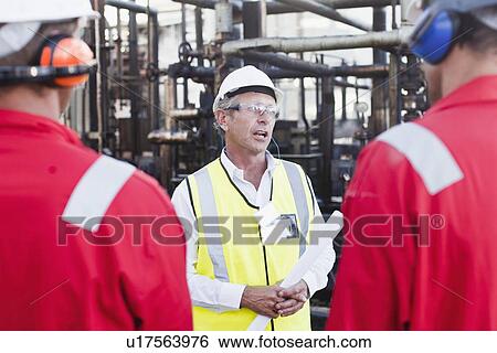 Workers talking at chemical plant View Large Photo Image Stock Photograph - Workers talking at chemical plant. Fotosearch