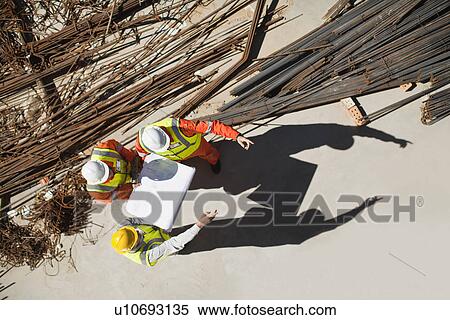 Workers talking at construction site View Large Photo Image Stock Photography - Workers talking at construction site. Fotosearch