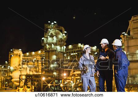 Workers talking at oil refinery View Large Photo Image Stock Image - Workers talking at oil refinery. Fotosearch