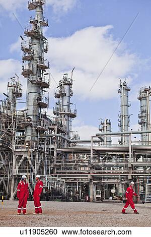 Workers talking at oil refinery View Large Photo Image Stock Image - Workers talking at oil refinery. Fotosearch