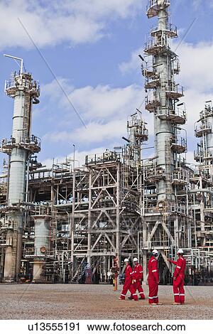 Workers talking at oil refinery View Large Photo Image Stock Image - Workers talking at oil refinery. Fotosearch