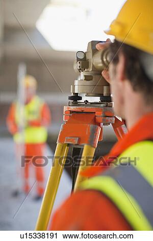 Workers using equipment on site View Large Photo Image Stock Image - Workers using equipment on site. Fotosearch
