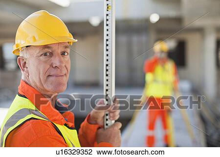 Workers using equipment on site View Large Photo Image Stock Image - Workers using equipment on site. Fotosearch