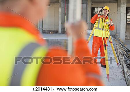 Workers using equipment on site View Large Photo Image Stock Photo - Workers using equipment on site. Fotosearch