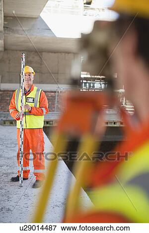 Workers using equipment on site View Large Photo Image Stock Photo - Workers using equipment on site. Fotosearch