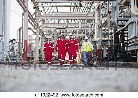 Workers walking at chemical plant View Large Photo Image Stock Image - Workers walking at chemical plant. Fotosearch