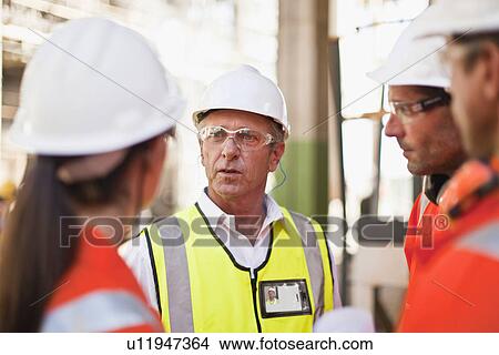 Workers walking at oil refinery View Large Photo Image Picture - Workers walking at oil refinery. Fotosearch