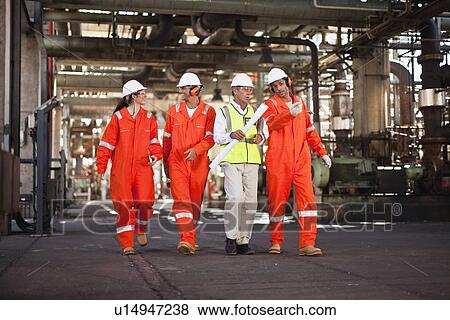 Workers walking at oil refinery View Large Photo Image Stock Photo - Workers walking at oil refinery. Fotosearch
