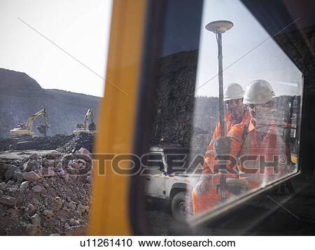 Stock Image - Workers with equipment at coal mine. Fotosearch