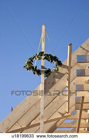 Stock Image - Wreath of plants on new building. Fotosearch