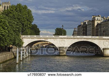 Arch bridge across the river, Pont Au Change, Seine River, Paris, France View Large Photo Image Stock Photo - Arch bridge across the river, Pont Au Change, Seine River, Paris, France. Fotosearch