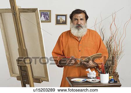 Stock Photo - Artist holding a palette. Fotosearch
