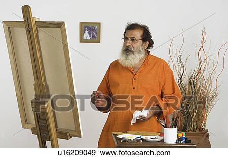 Artist looking at painting View Large Photo Image Stock Photo - Artist looking at painting. Fotosearch
