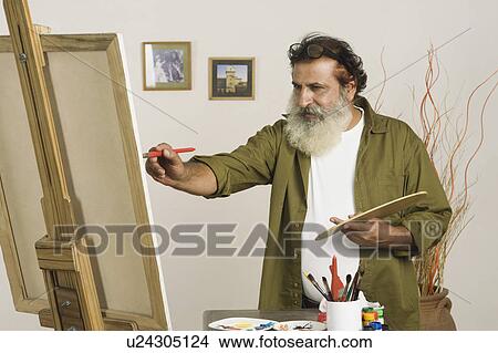 Artist painting on a canvas View Large Photo Image Picture - Artist painting on a canvas. Fotosearch