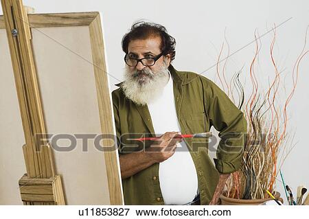 Artist painting on a canvas View Large Photo Image Stock Photo - Artist painting on a canvas. Fotosearch