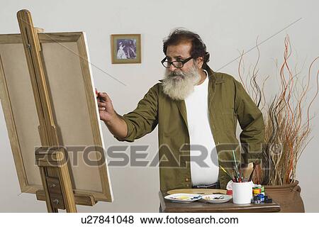 Artist painting on a canvas View Large Photo Image Stock Photo - Artist painting on a canvas. Fotosearch