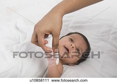Baby holding finger of mother View Large Photo Image Stock Image - Baby holding finger of mother. Fotosearch