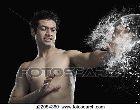 Bare chested man splashed with water View Large Photo Image Stock Image - Bare chested man splashed with water. Fotosearch