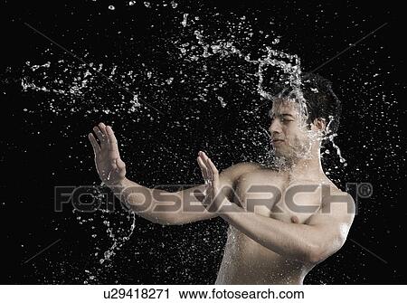 Bare chested man splashed with water View Large Photo Image Stock Image - Bare chested man splashed with water. Fotosearch