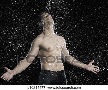 Bare chested man splashed with water View Large Photo Image Stock Photo - Bare chested man splashed with water. Fotosearch
