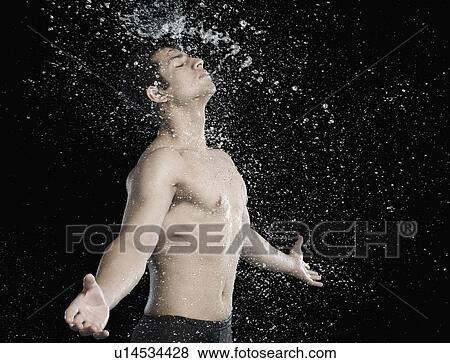 Bare chested man splashed with water View Large Photo Image Stock Photo - Bare chested man splashed with water. Fotosearch