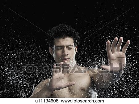 Bare chested man splashed with water View Large Photo Image Stock Photograph - Bare chested man splashed with water. Fotosearch
