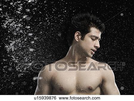 Stock Photograph - Bare chested man splashed with water. Fotosearch