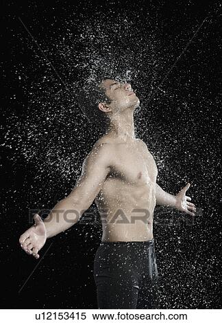Stock Photography - Bare chested man splashed with water. Fotosearch