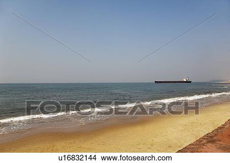 Beach with a container ship in the background, Goa, India View Large Photo Image Picture - Beach with a container ship in the background, Goa, India. Fotosearch